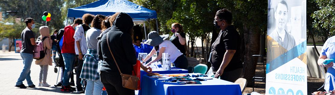 A group of Pima Tables at an event for the community at Pima's Downtown Campus